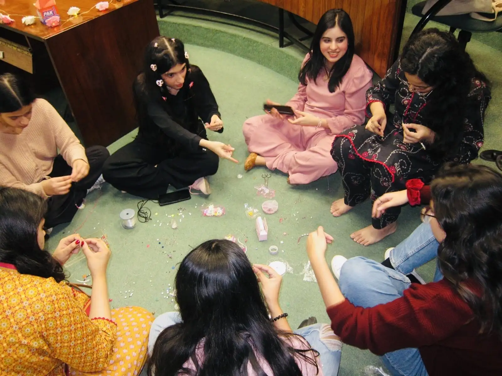 Making bead bracelets on the floor