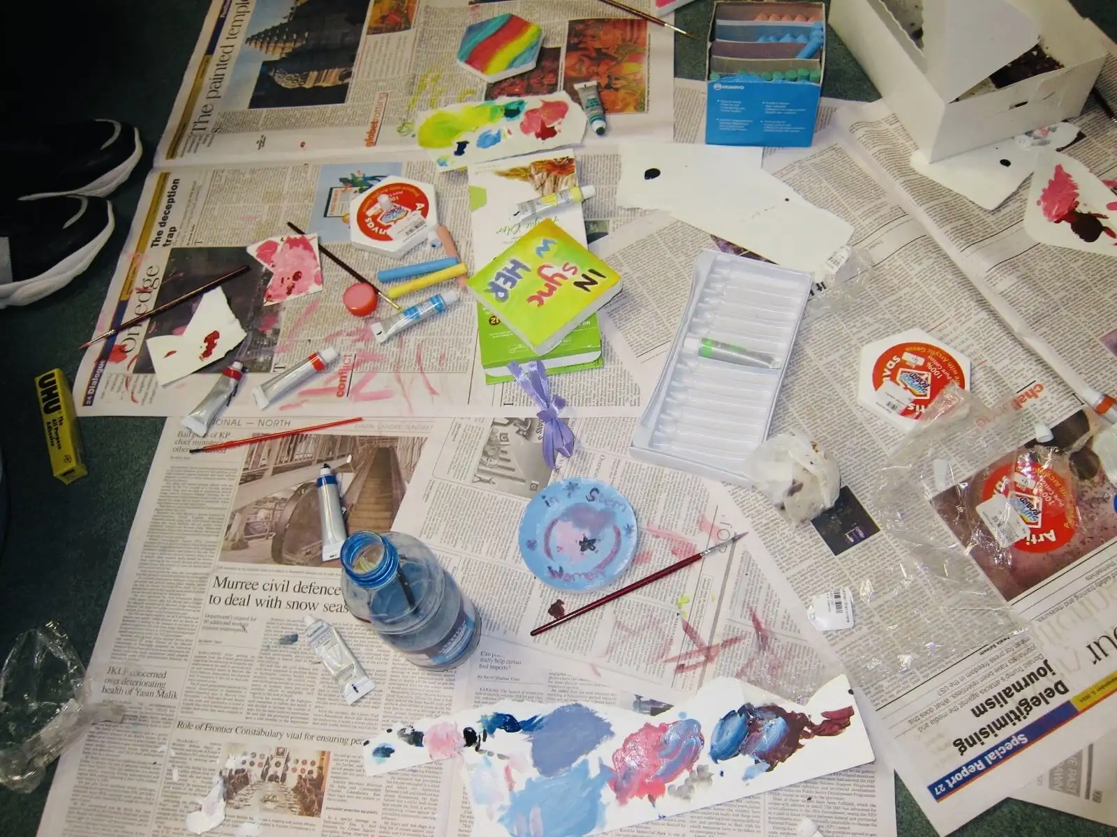 Paint, brushes and old newspapers at a craft night